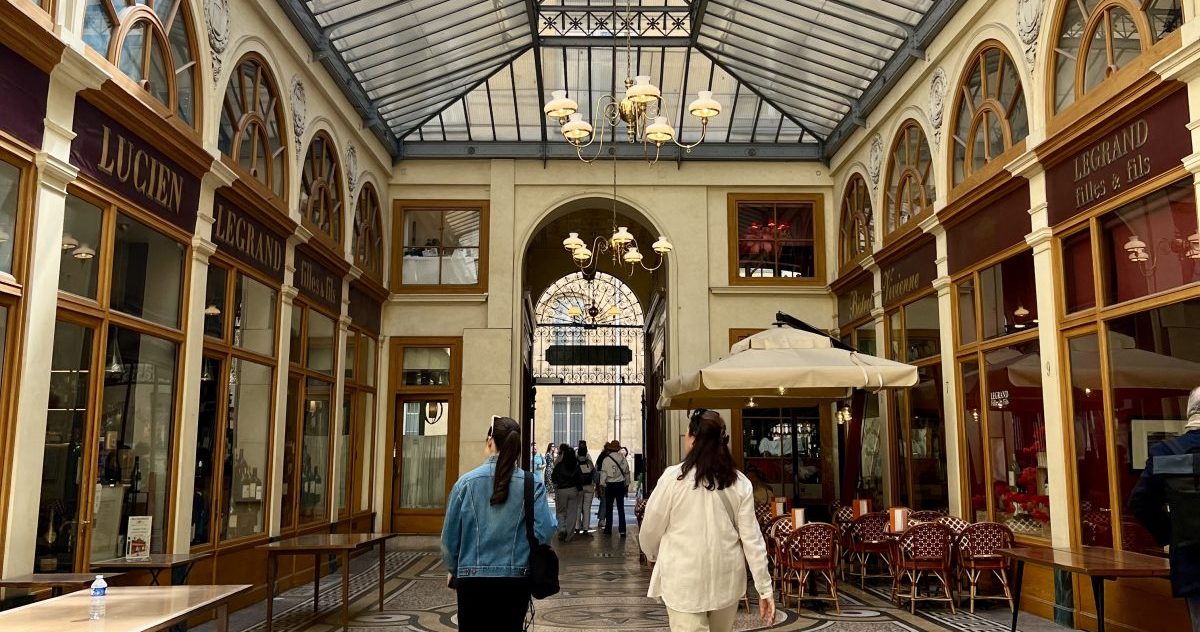 Two women walking through the hidden covered passages in Paris France